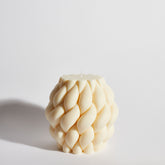 Boujie Centrestage Knitted Cable Decorative Candle in ivory soy wax, front view.